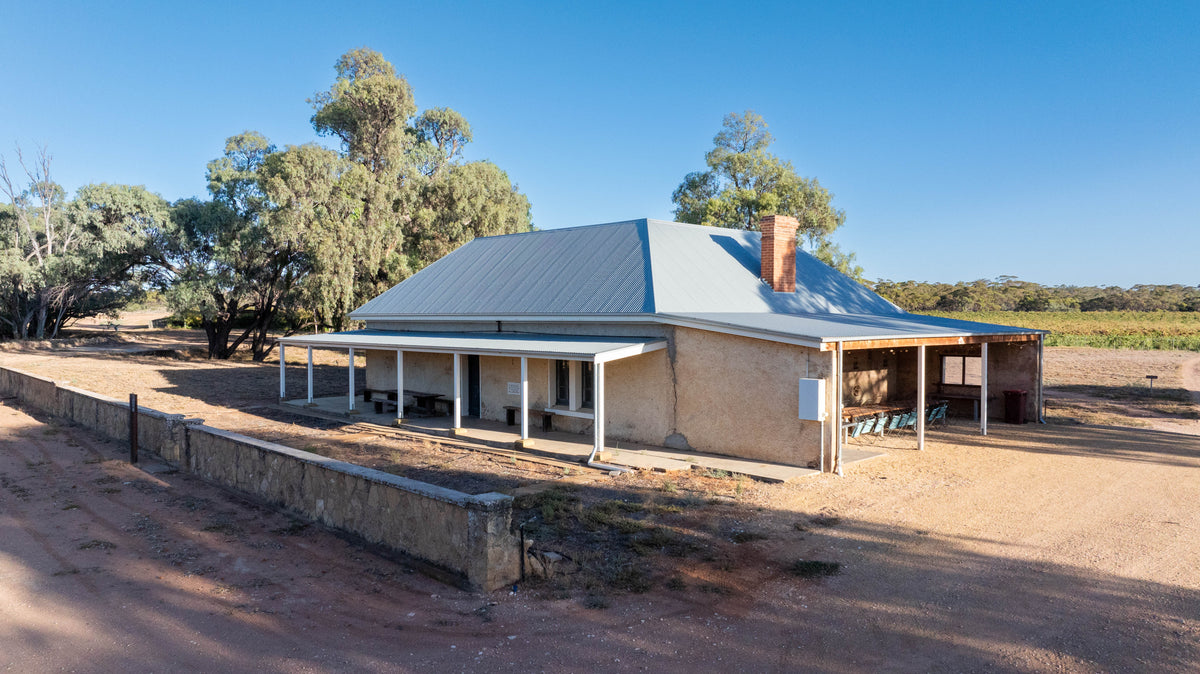 Old stone homestead with a corrugated iron roof and a verandah